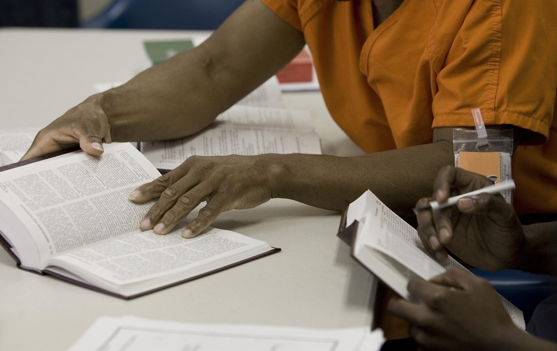 Two men read law books at the facility library inside the Willacy Detention Center on May 10, 2007 in Raymondville, Texas.